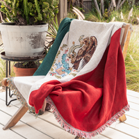 A throw blanket featuring the colors and symbols of the Mexican flag, displayed on a chair outdoors.