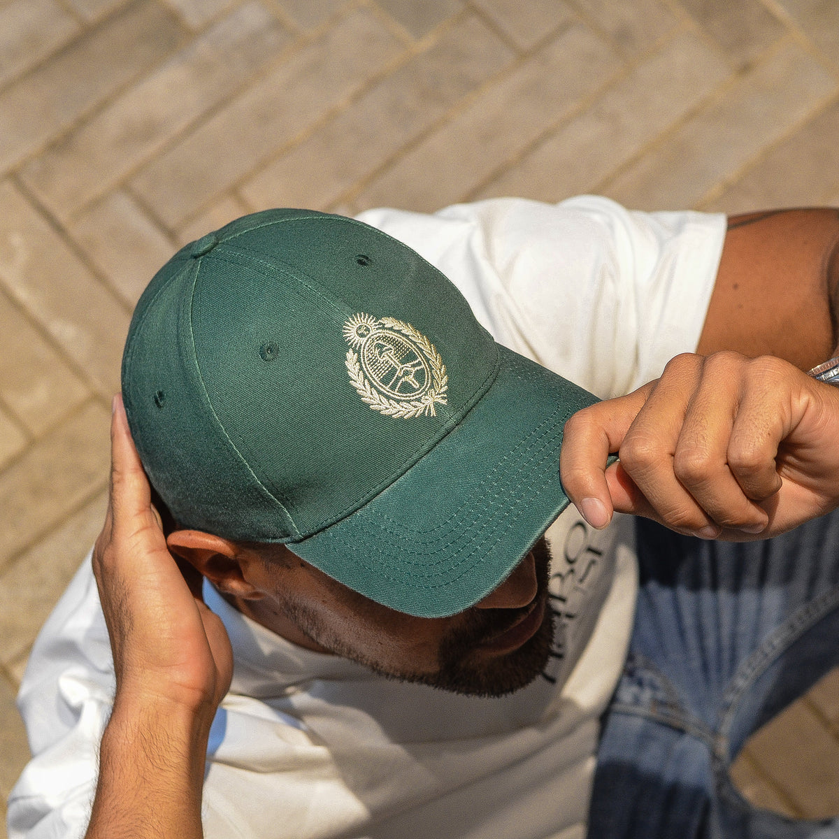 A man wearing a dark green baseball cap with a white embroidered Argentina emblem