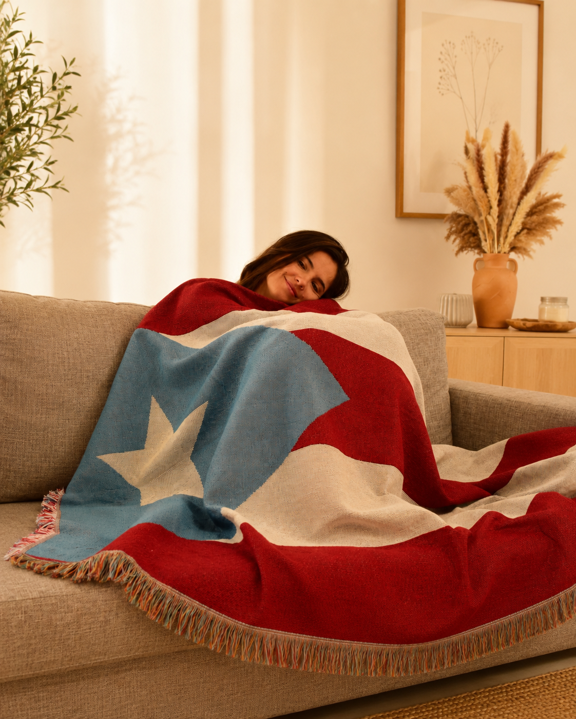 Woman with the Puerto Rico Flag woven throw blanket Ceibo House at cozy living room