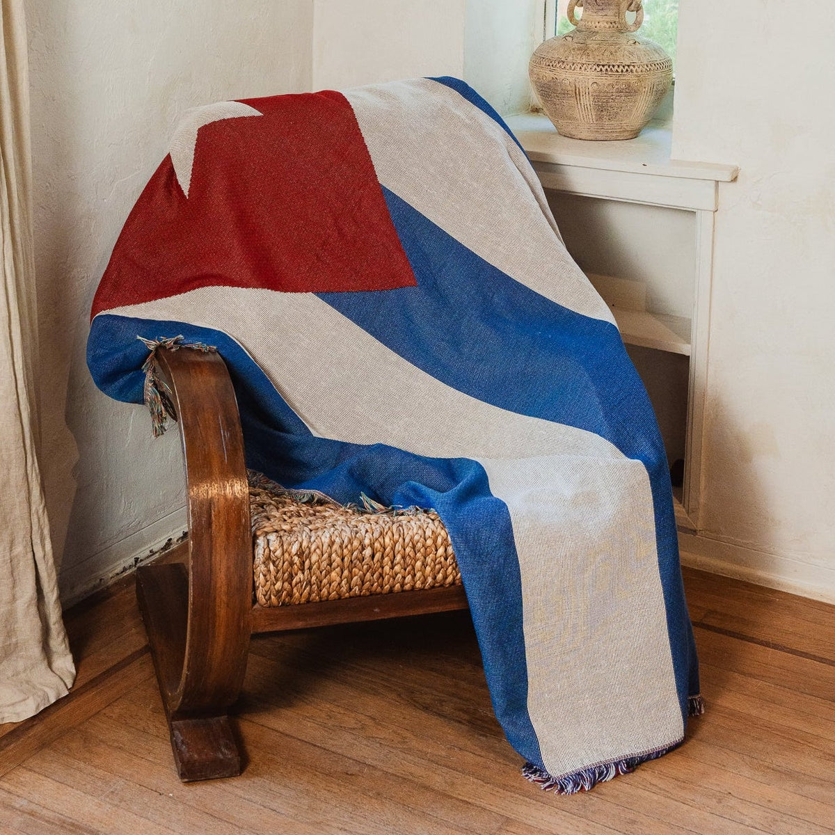 Cuba flag woven throw blanket draped over an armchair in a sunlit living room