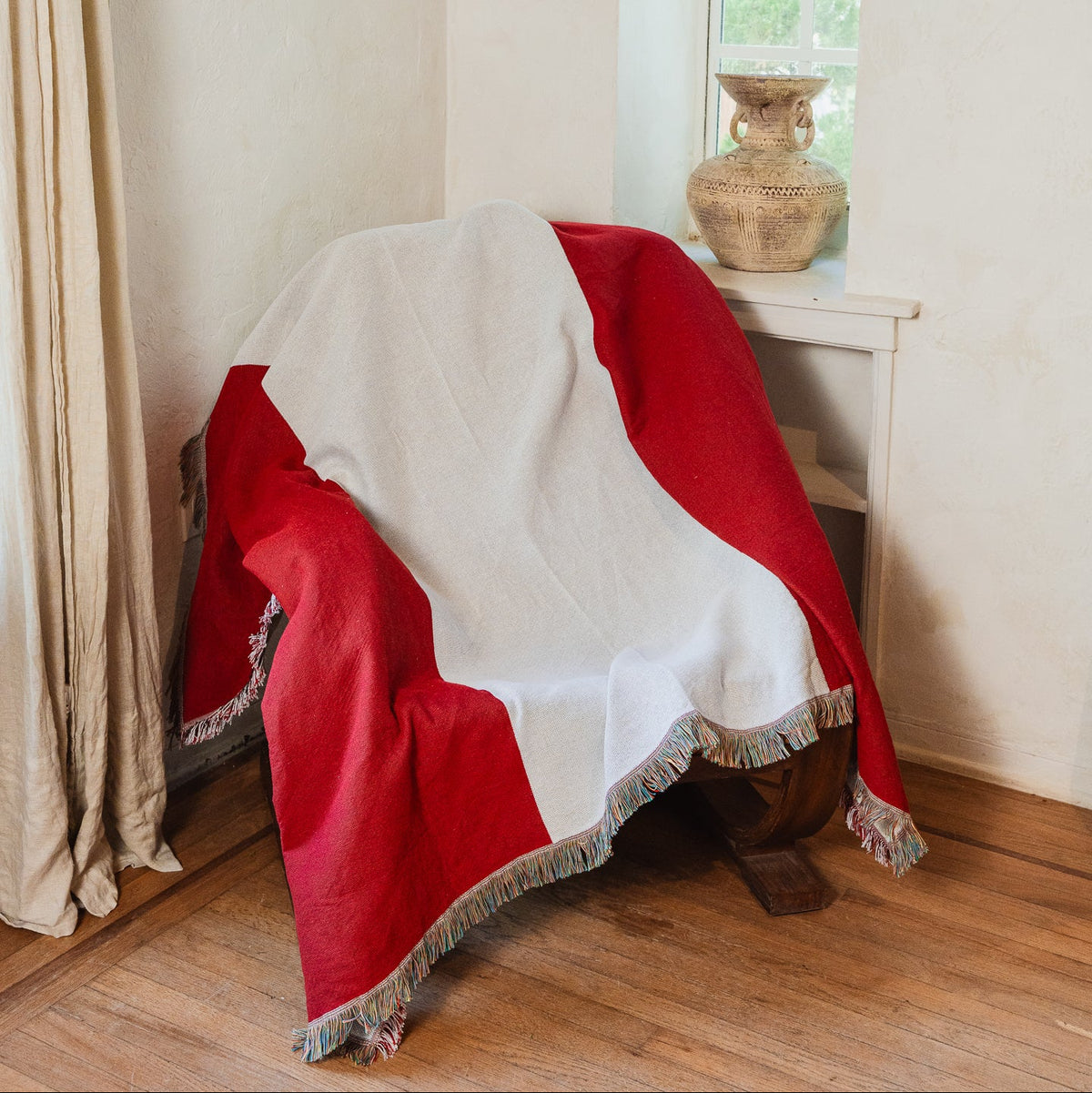 Peru flag woven throw blanket draped over an armchair in a sunlit living room