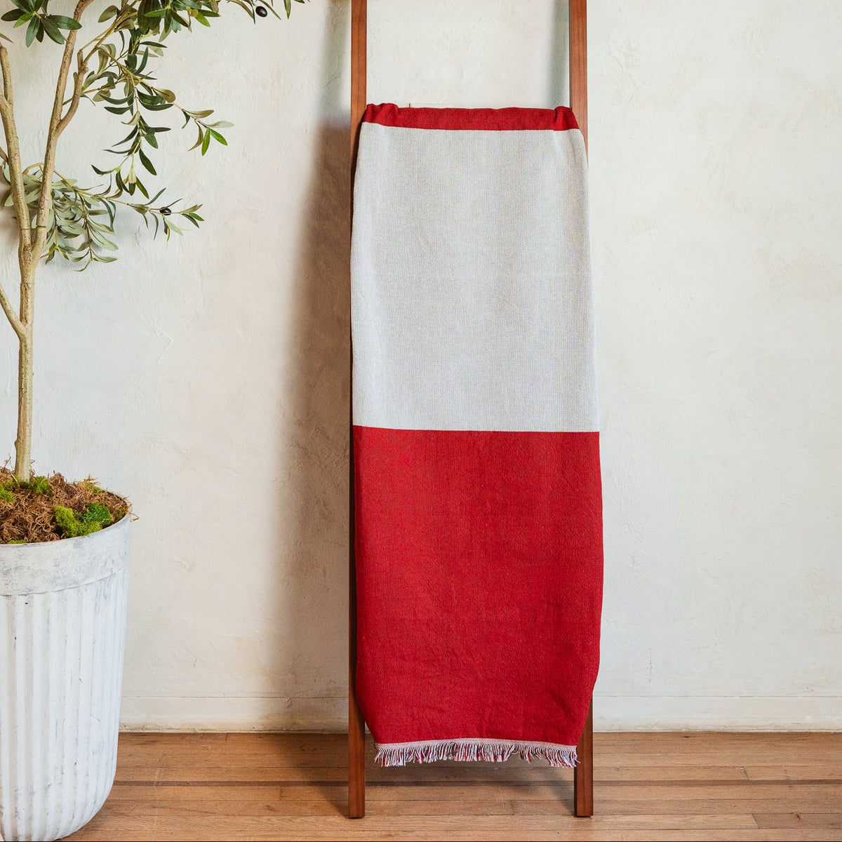 Peru flag woven throw blanket hanging on a wooden blanket ladder